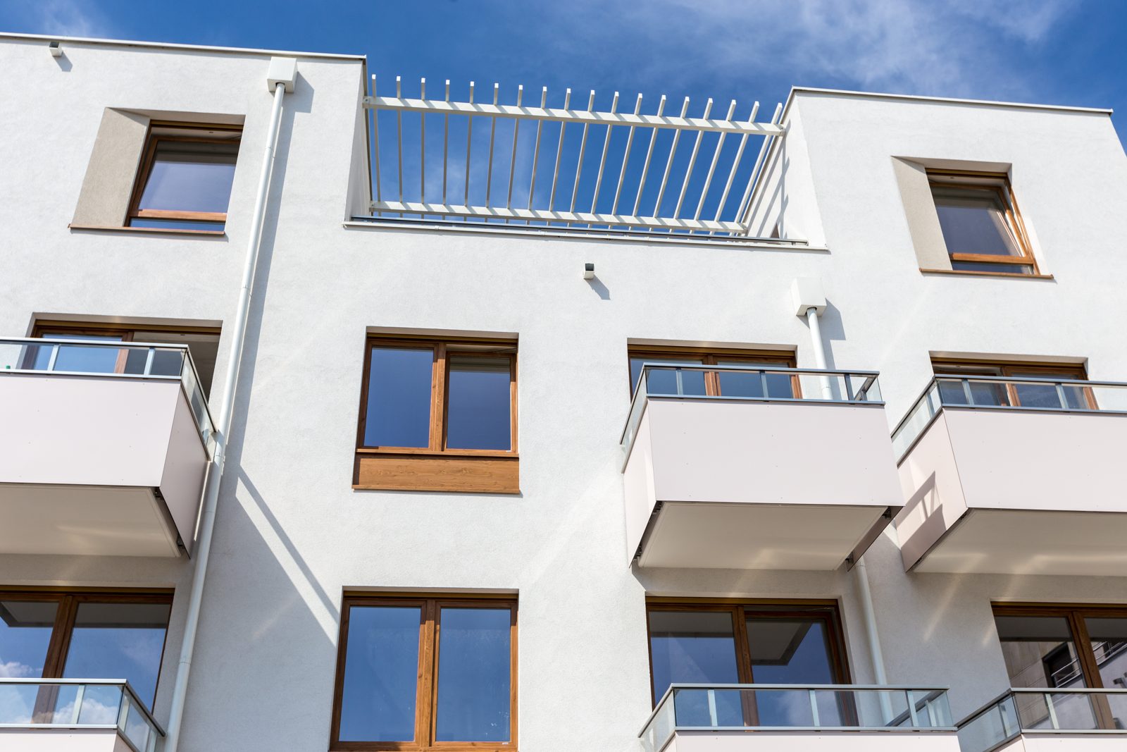 Apartment block with wood-effect windows and glass balconies